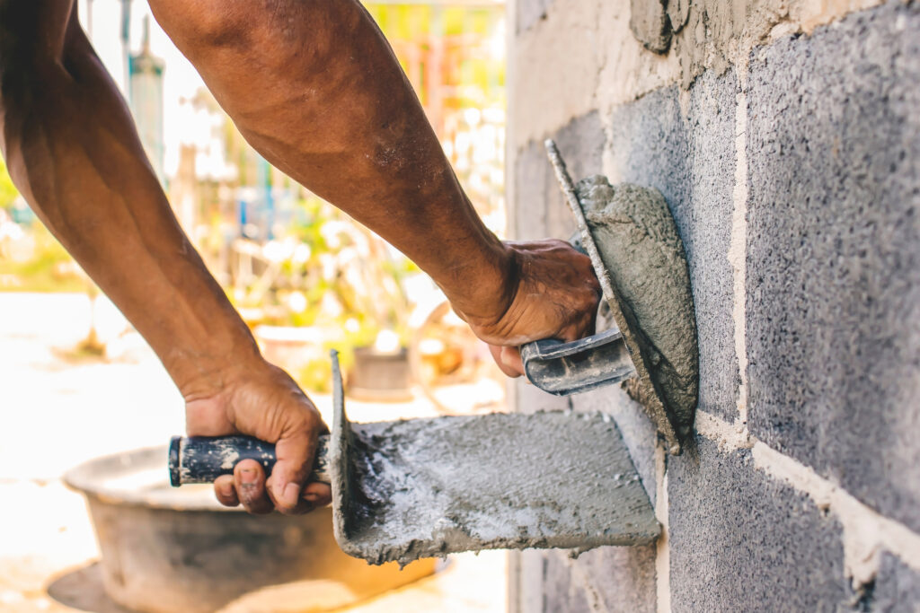 Close up,Of,Workers,Using,Plaster,Trowel,To,Plaster,The,Walls