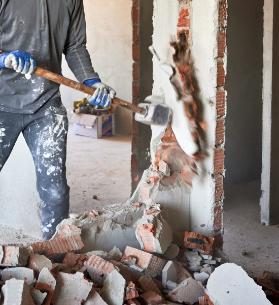 Close,Up,Of,Sledgehammer,Blow,On,Brick,,Plaster.,Workman,Striking