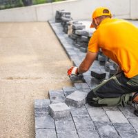 A,Construction,Worker,Carefully,Positions,Cobblestones,To,Create,A,New